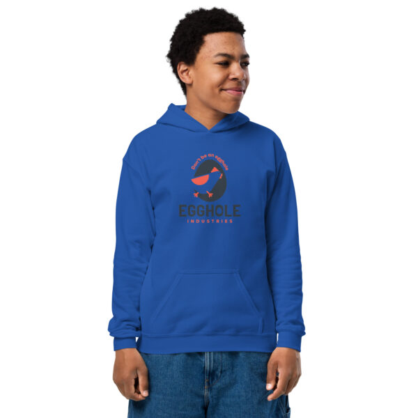 A person wearing a blue hoodie with a logo on it.