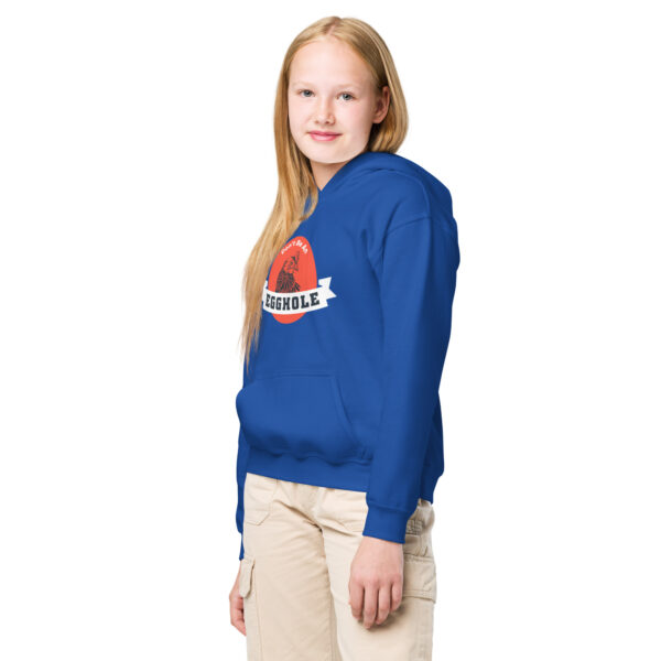 A girl standing in front of the camera wearing a blue sweatshirt.