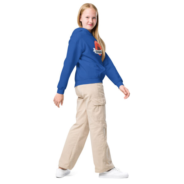 A girl in blue shirt and beige pants