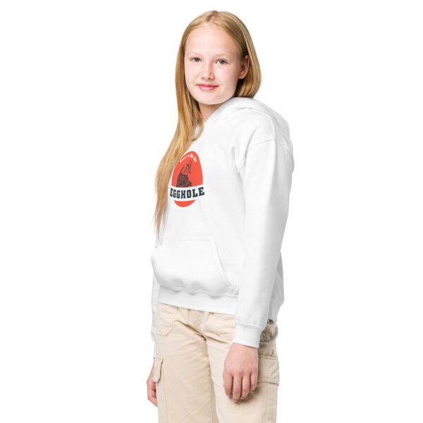 A girl standing in front of the camera wearing white pants and a sweatshirt.