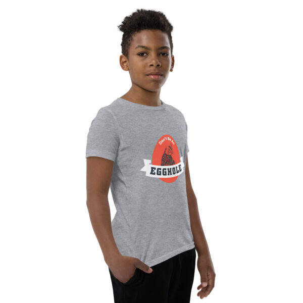 A young person wearing a t-shirt with the words " chicago " on it.