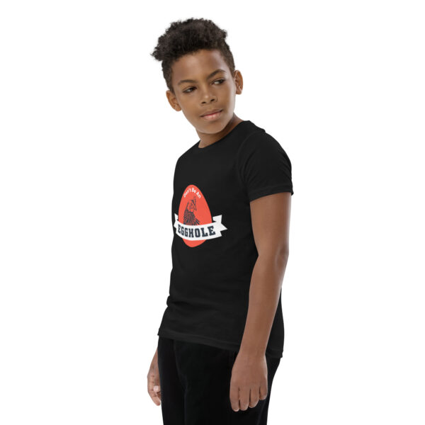 A young boy wearing black pants and a t-shirt.