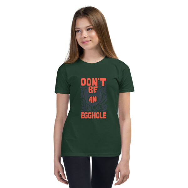 A girl wearing a t-shirt with the words " don 't be an egomole ".