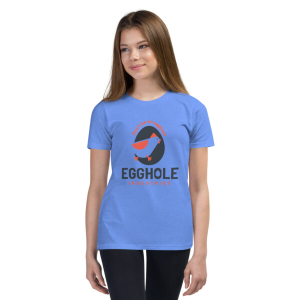 A girl wearing a blue t-shirt with an egg hole logo.