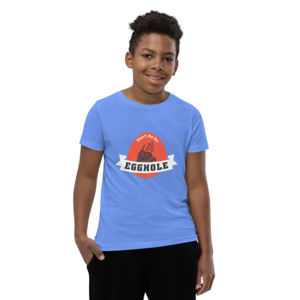 A kid wearing a blue t-shirt with the word " redbubble " on it.