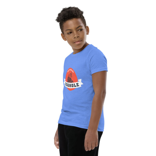 A boy wearing a blue t-shirt with the word " rebels ".