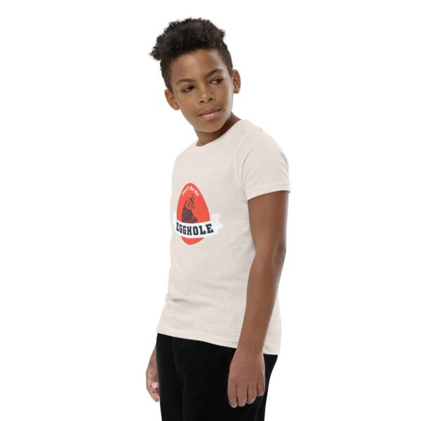 A young boy wearing black pants and white t-shirt.