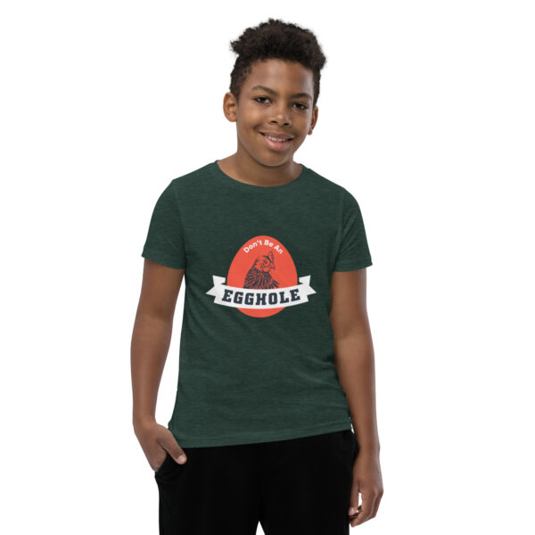 A kid wearing a t-shirt with the word assembly on it.