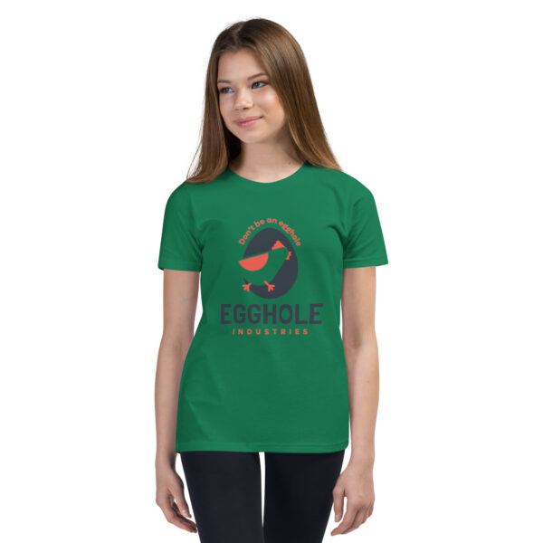 A girl wearing a green t-shirt with the words " evolve ".