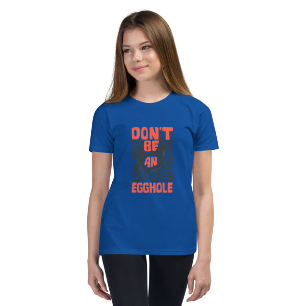 A girl wearing a blue t-shirt with the words " don 't be a disgrace ".