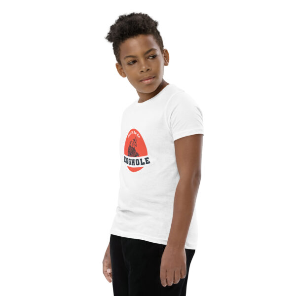 A young boy wearing black pants and white t-shirt.