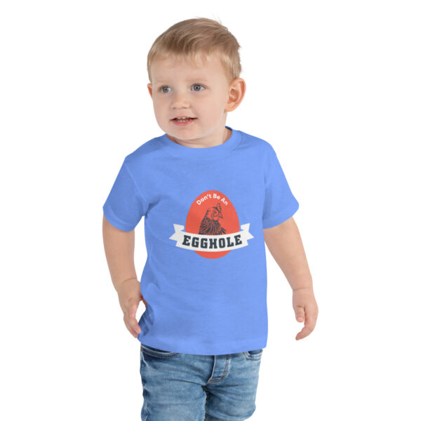 A toddler wearing a t-shirt with the name of egorole