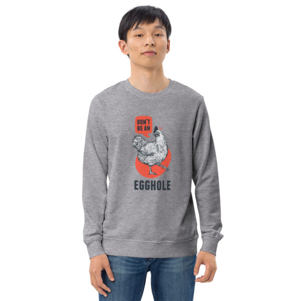 A man wearing a gray sweatshirt with an image of a cat.