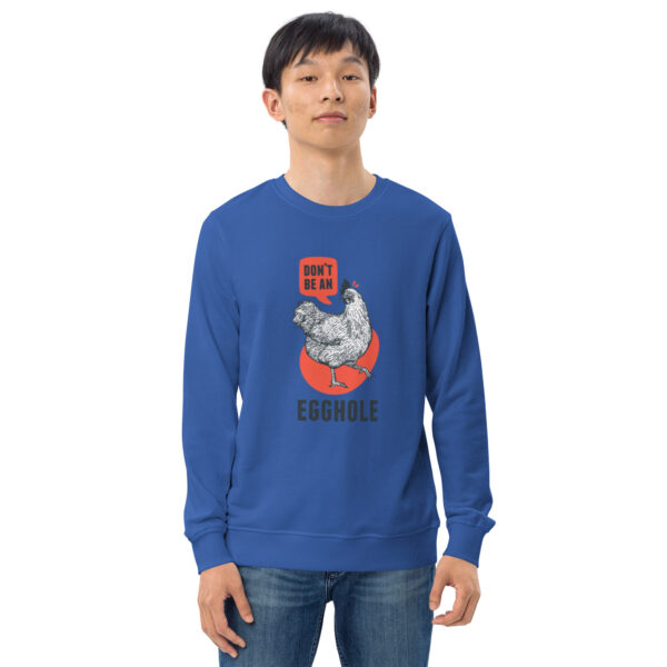 A man wearing a blue sweatshirt with an image of a cat.