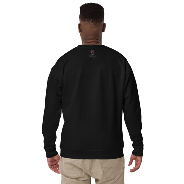 A man wearing a black sweatshirt with an image of a person.