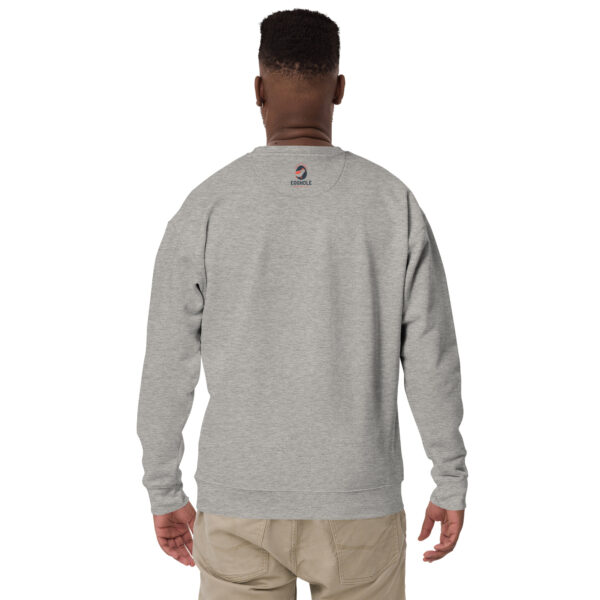 A man wearing a gray sweatshirt with an image of a person 's face on it.