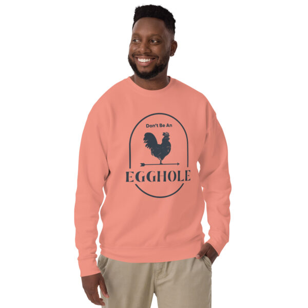 A man wearing an egghole sweatshirt with a rooster on it.