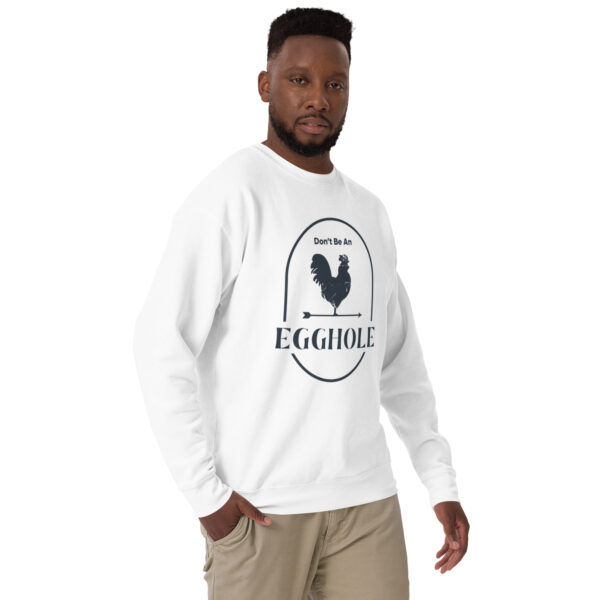 A man wearing a white sweatshirt with an egg shell logo.