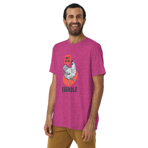 A man wearing a pink t-shirt with an image of a chicken.