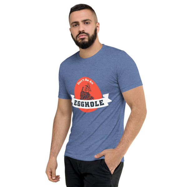 A man wearing a blue t-shirt with the word scramble on it.