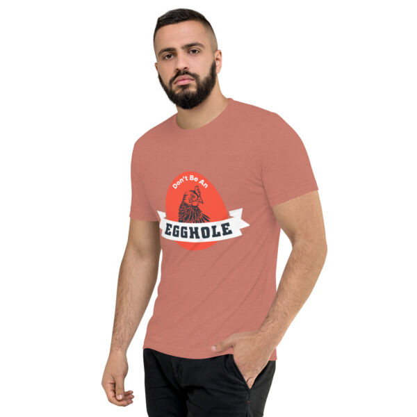 A man wearing a t-shirt with the word " grenade ".