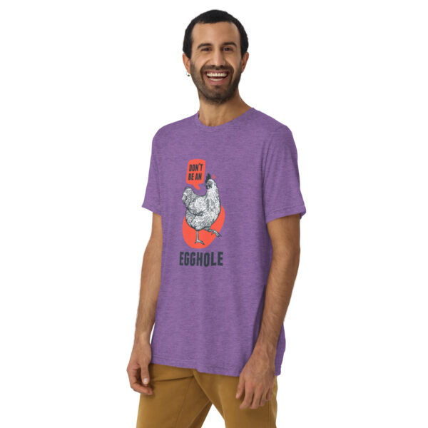 A man wearing a purple t-shirt with an image of a person holding something.