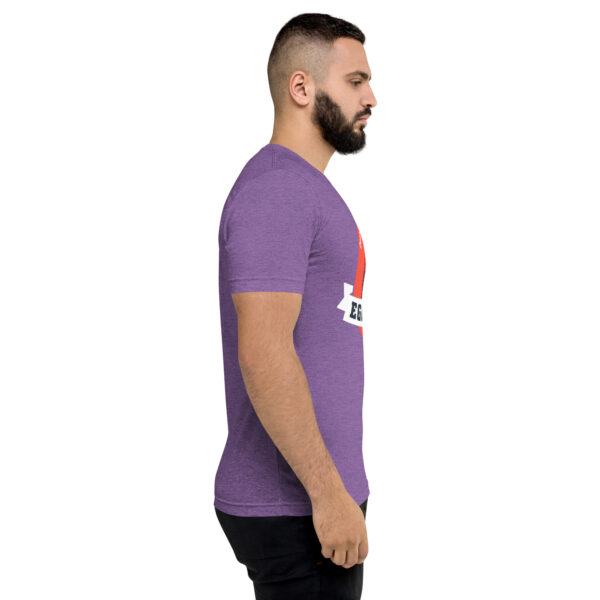 A man with a beard is wearing a purple t-shirt.