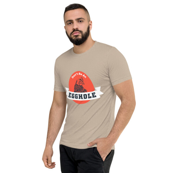 A man wearing a t-shirt with the words " crumble " on it.