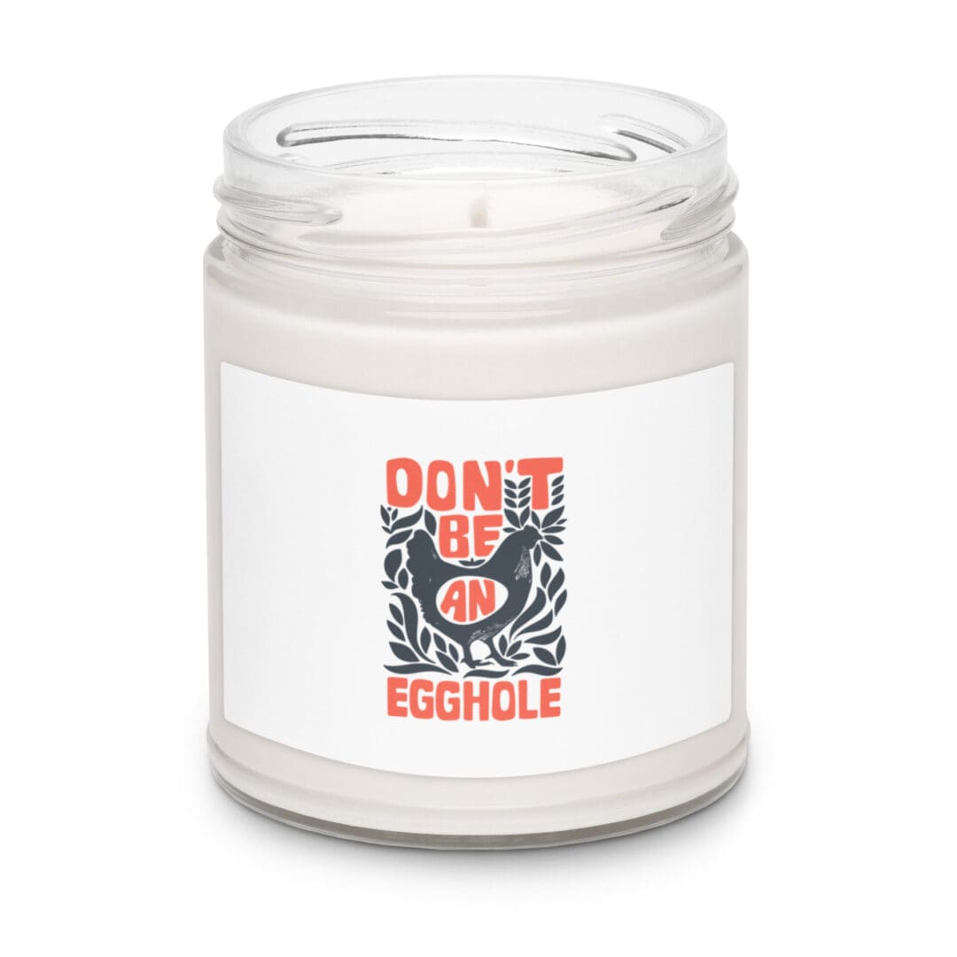 A white candle jar with a humorous label featuring a cartoon bird and text.