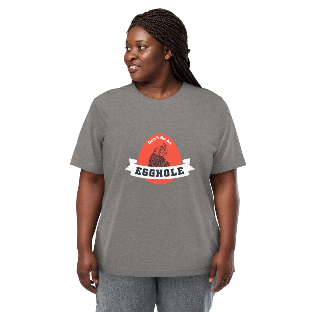 Smiling woman wearing a gray T-shirt with a colorful graphic design.