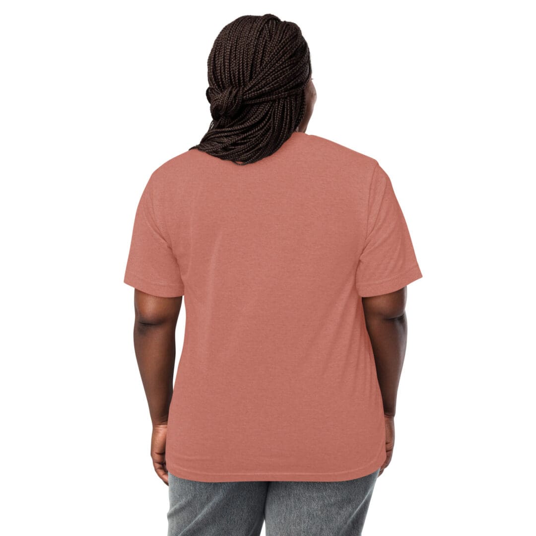 Rear view of a person wearing a plain coral t-shirt and gray pants.