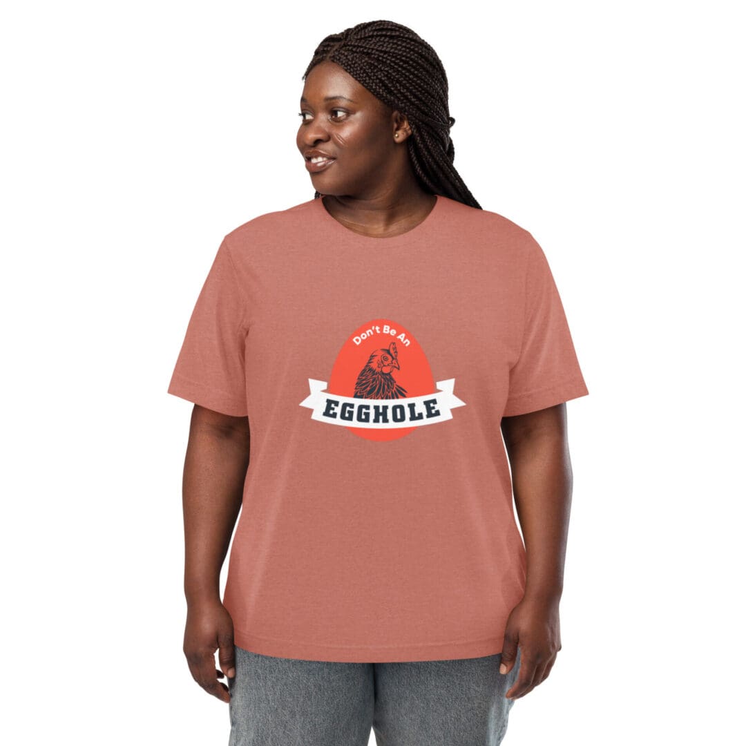 Smiling woman wearing a rust-colored t-shirt with a graphic design.