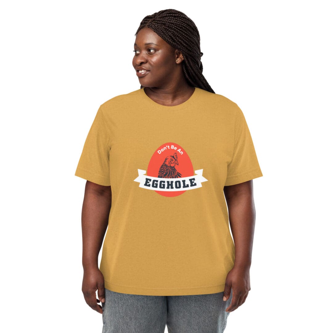 A smiling woman wearing a mustard yellow t-shirt with a red graphic and text.