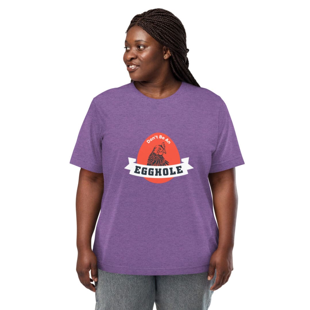 Smiling woman wearing a purple t-shirt with a colorful graphic design.