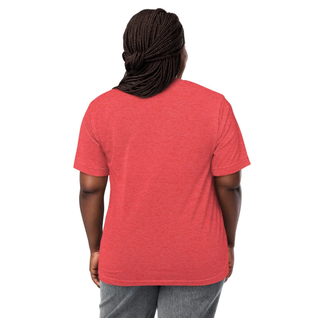 Person wearing a red t-shirt and gray pants, facing away from the camera.