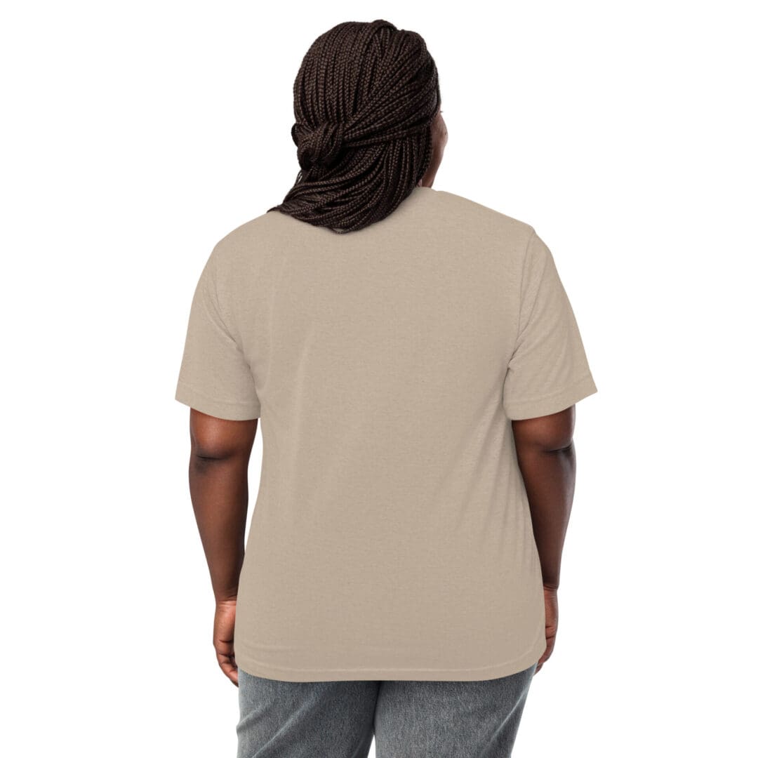 Rear view of a person wearing a beige t-shirt and gray pants.