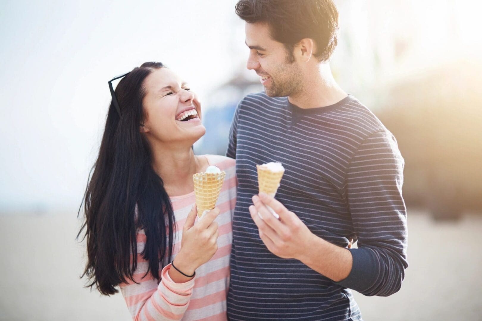 A man and a woman together wearing funny T-shirts.